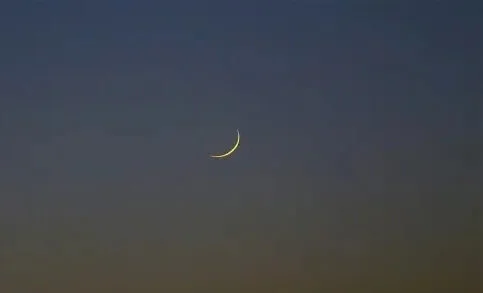 Crescent moon over Dakar sky