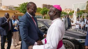 Close-up of Prime Minister Ousmane Sonko and Archbishop André Guéye during discussions