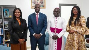 Prime Minister Ousmane Sonko seated with Archbishop André Guéye