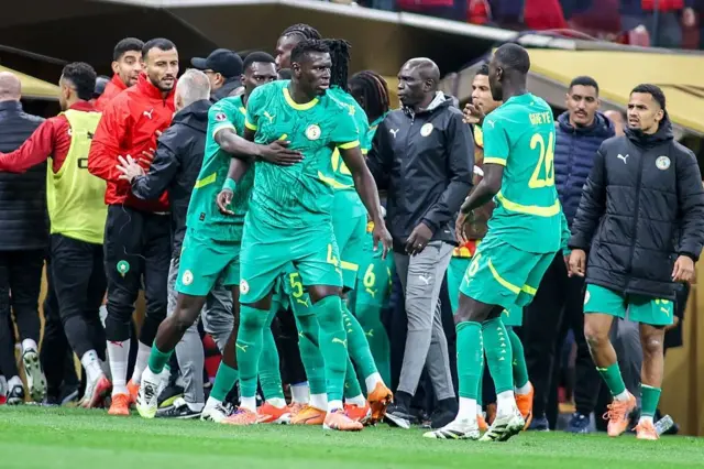 Senegalese players and staff protesting the referee's decisions during the CAN 2025 final