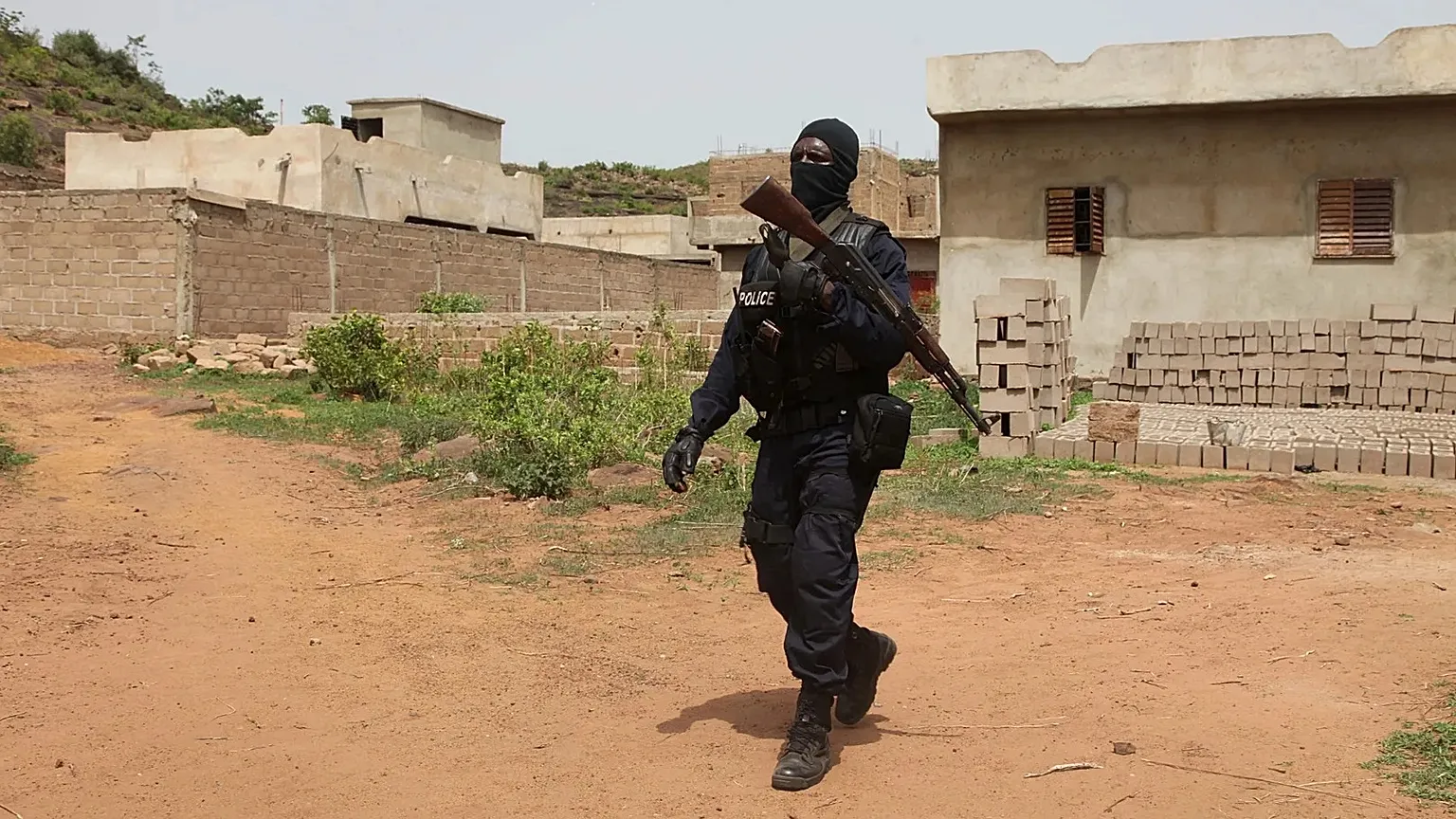 A Malian police officer patrols near the Campement Kangaba tourist complex outside Bamako on June 19, 2017