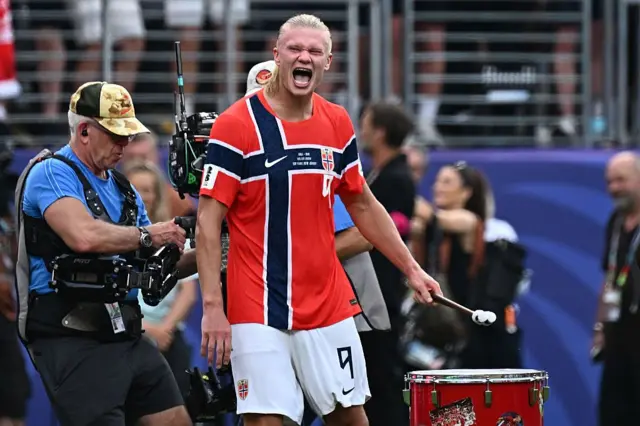 Norwegian striker Erling Braut Haaland plays a drum during celebrations after Brazil's Round of 16 win over Norway at MetLife Stadium in East Rutherford