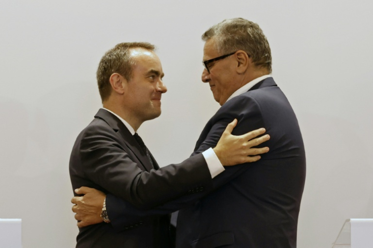 French and Moroccan leaders embrace after talks in Rabat