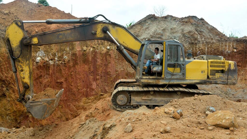 A Chinese mining employee operates a bulldozer at a gold mining site near Betare Oya, Cameroon, April 4, 2018.