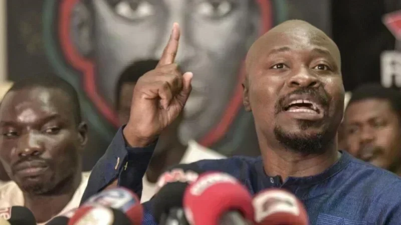 Portrait of Guy Marius Sagna at a press conference