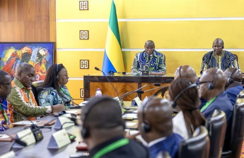 Leaders of Gabon and Ghana shake hands during a signing ceremony