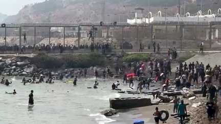 Migrants arriving on the coast of the Spanish enclave of Ceuta after swimming past the border barrier between Morocco and Spain, July 30, 2026