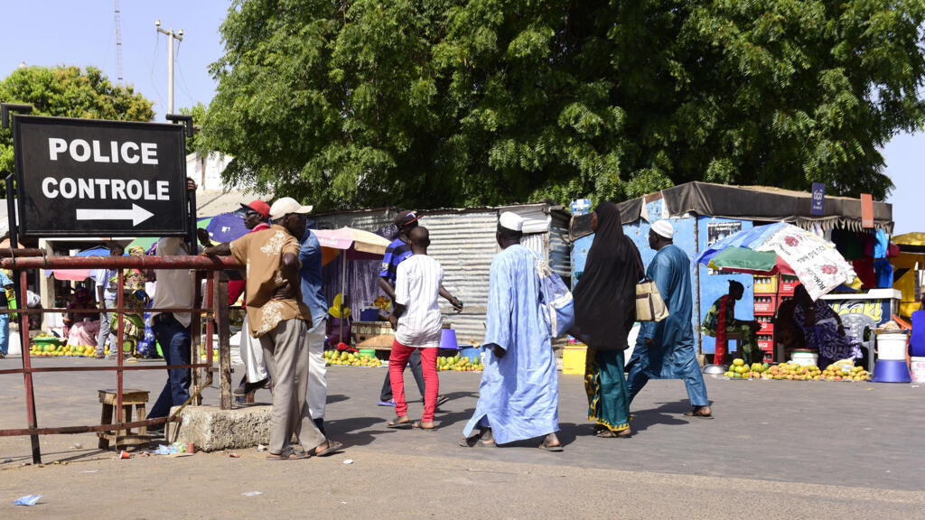 At Karang, Senegal, on May 10, 2016, travelers pass through police control to enter Gambia.