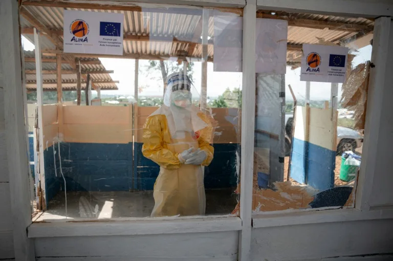 Health workers in protective gear treating Ebola patients in a clinic