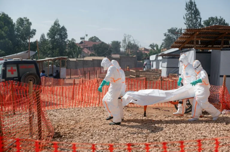 Health workers in protective gear treating Ebola patients in a Congolese health facility